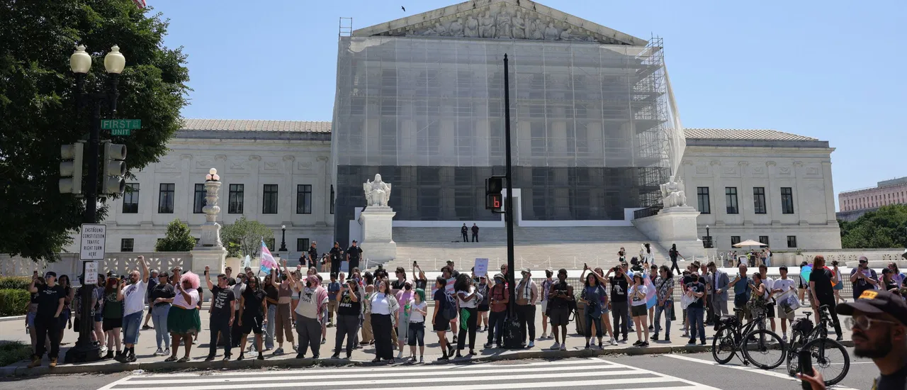Demonstrators cheer as U.S. Capitol Police arrest demonstrators blocking a road in front of the Supreme Court